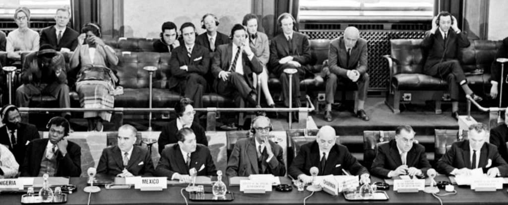 Men and women sat on chairs at the Conference of the 18-nation Committee on Disarmament 1962. Photo credit: United Nations photostream. CC BY-NC-ND 2.0