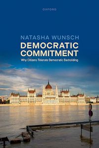 Cover of 'Democratic Commitment' book, featuring the Hungarian Parliament Building reflected in the Danube River under a cloudy sky. Title and author's name are in white text.