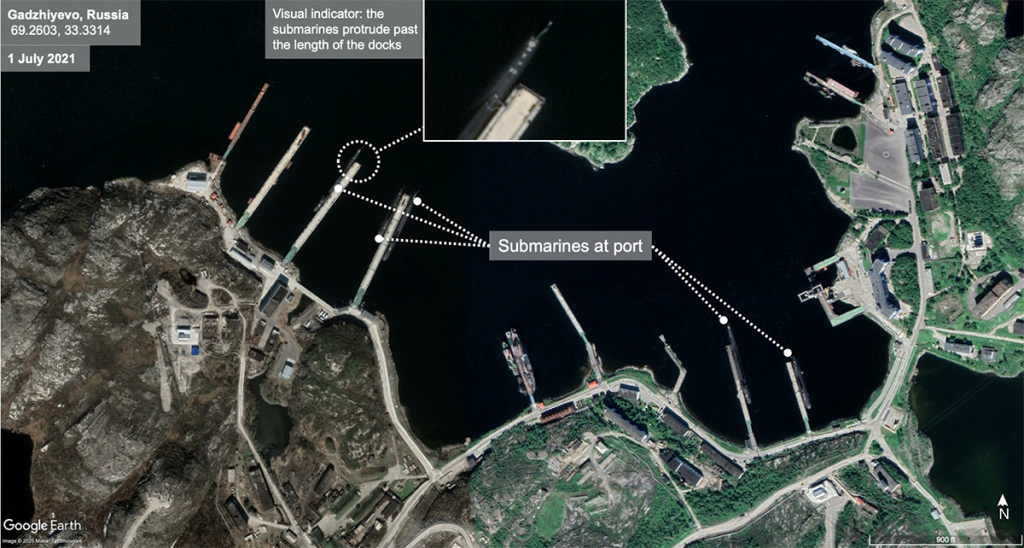 Satellite view of a Russian naval base on July 1, 2021, showing submarines docked at port, with an inset highlighting a submarine extending past the dock.