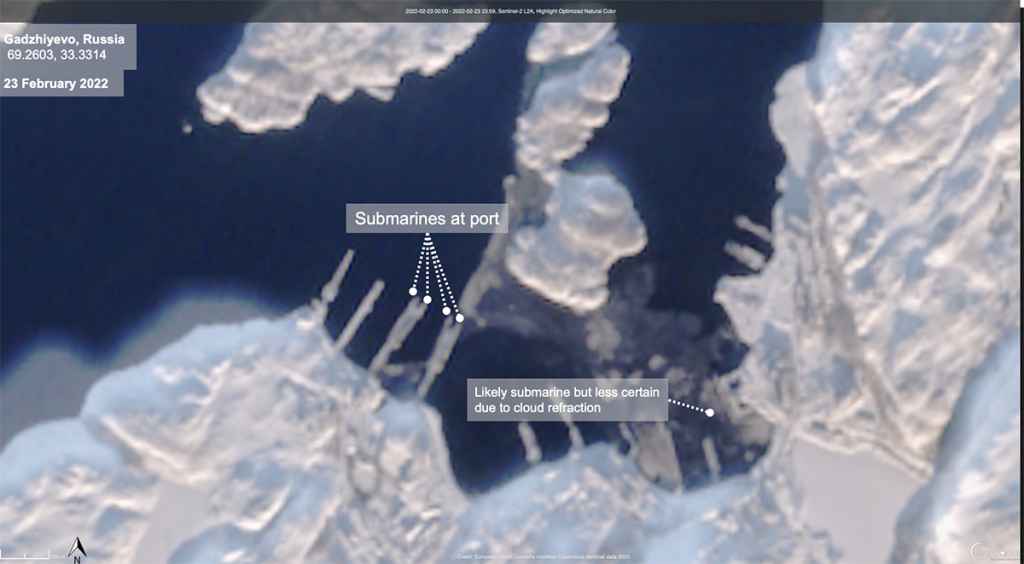 Satellite view of Gadzhiyevo, Russia on Feb 23, 2022, showing ice-covered waters and submarines at port.