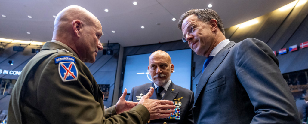 Supreme Allied Commander Europe, General Christopher G. Cavoli and Chair of the Military Committee Admiral Giuseppe Cavo Dragone wear military uniforms and NATO Secretary General Mark Rutte wears a blue suit and glasses.